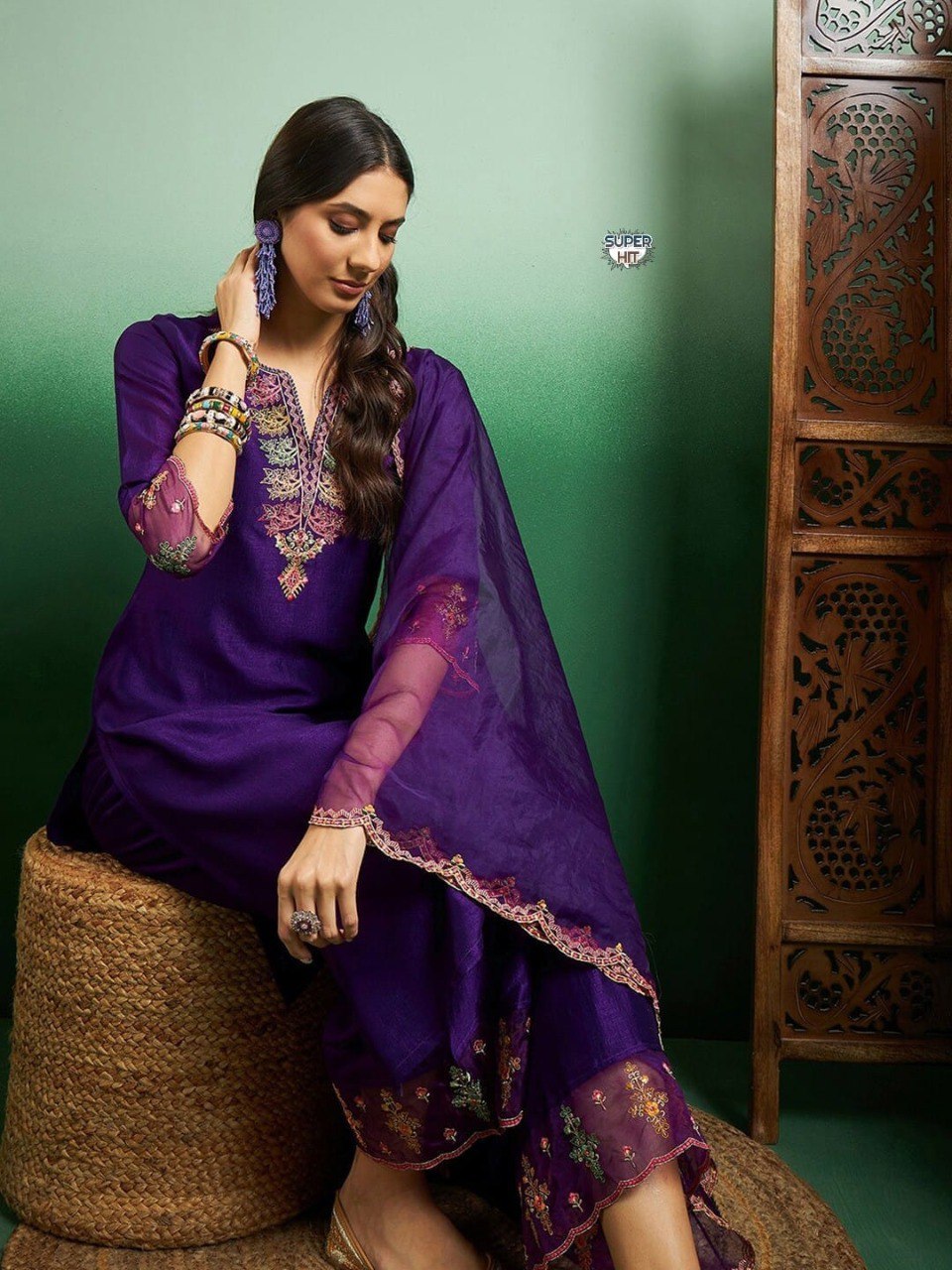 Close-up of intricate gold and floral embroidery on the purple kurti neckline