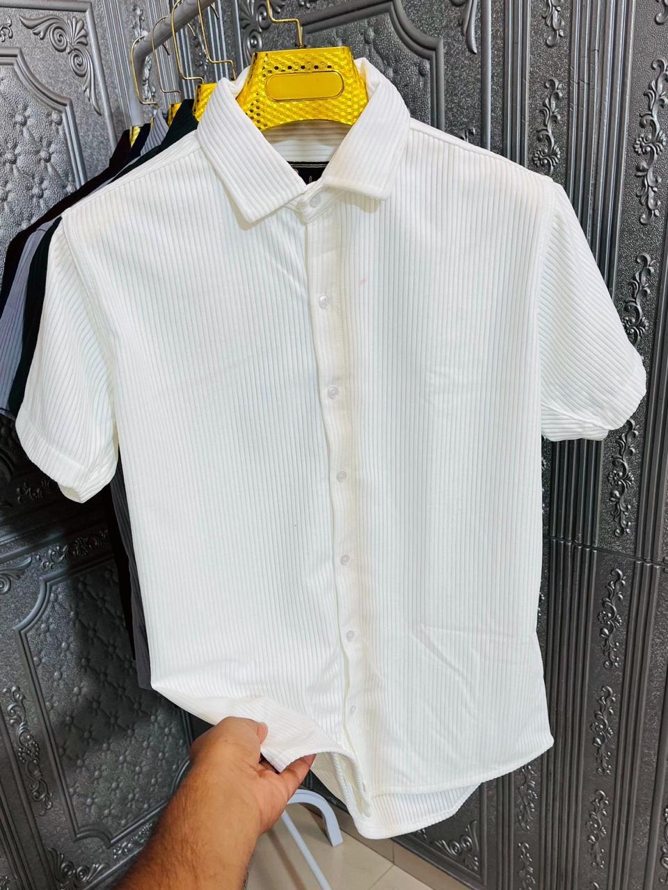 Men's white corduroy half sleeve casual shirt held by hand.