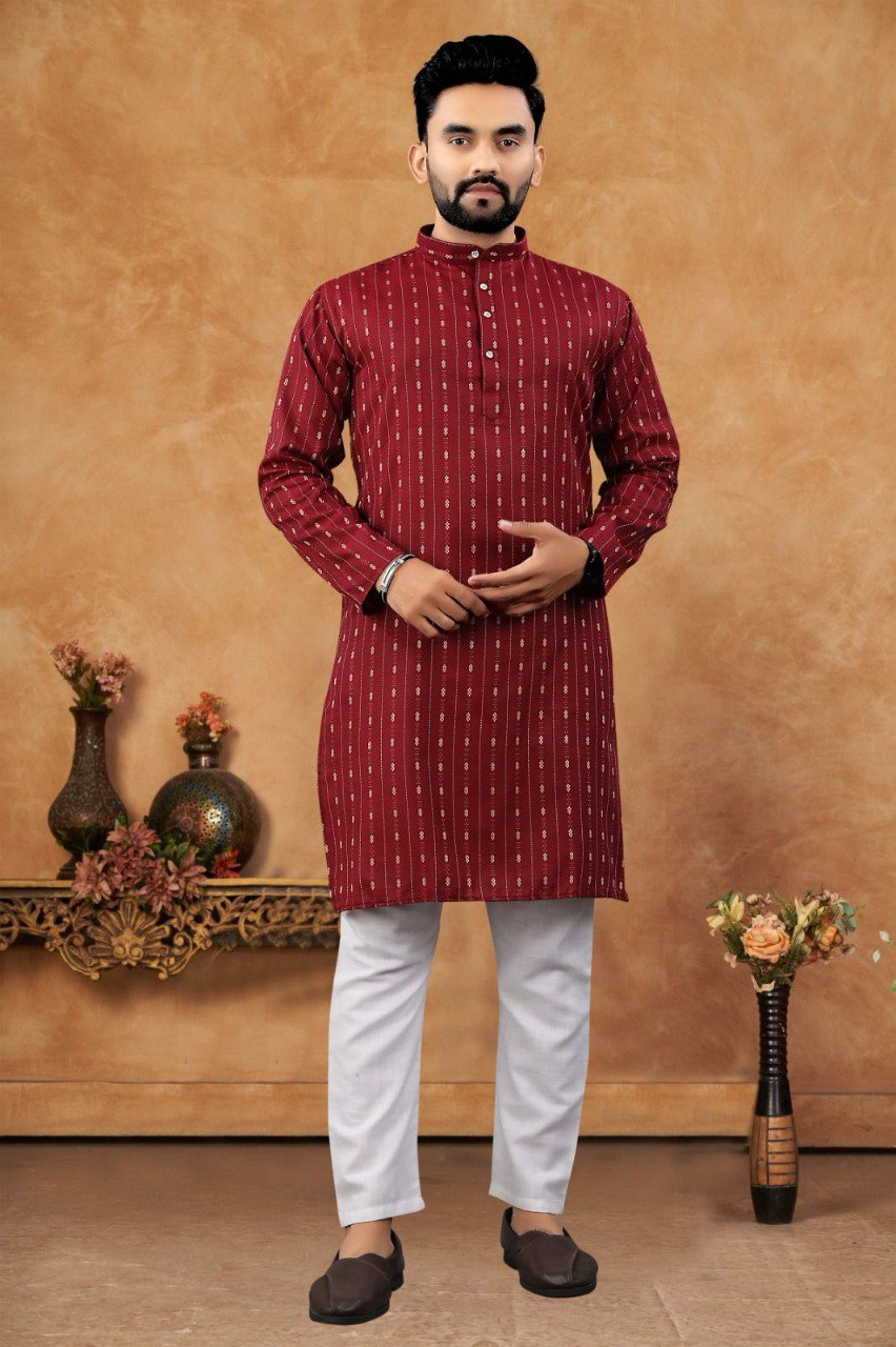Stylish man posing in a maroon cotton jacquard kurta with intricate vertical patterns and white pajama from TRENDBUY