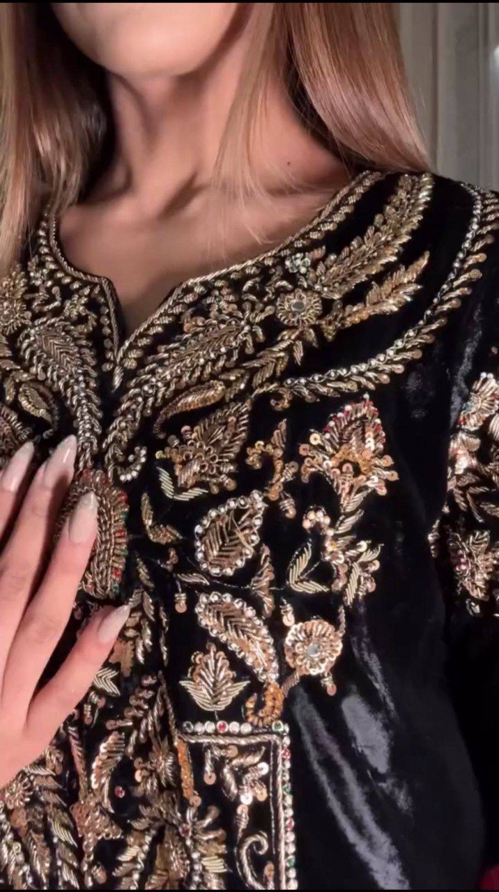 Close-up of black velvet kurti with intricate gold sequins and zari embroidery.
