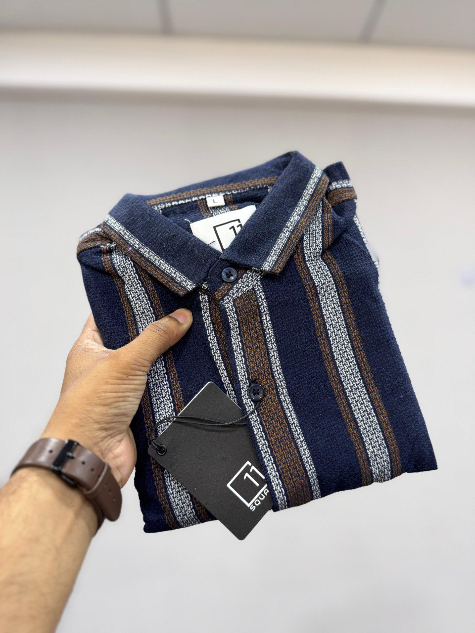 TRENDBUY Men's full sleeve striped shirt in navy blue, brown, and white, folded with tag