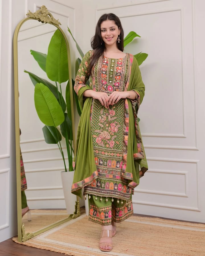 Model wearing a vibrant green plus size simmer palazzo suit with intricate mirror and print work.