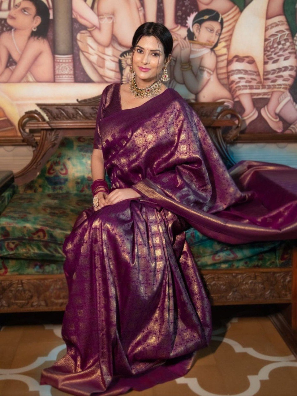 Woman draped in a luxurious purple lichi silk saree.