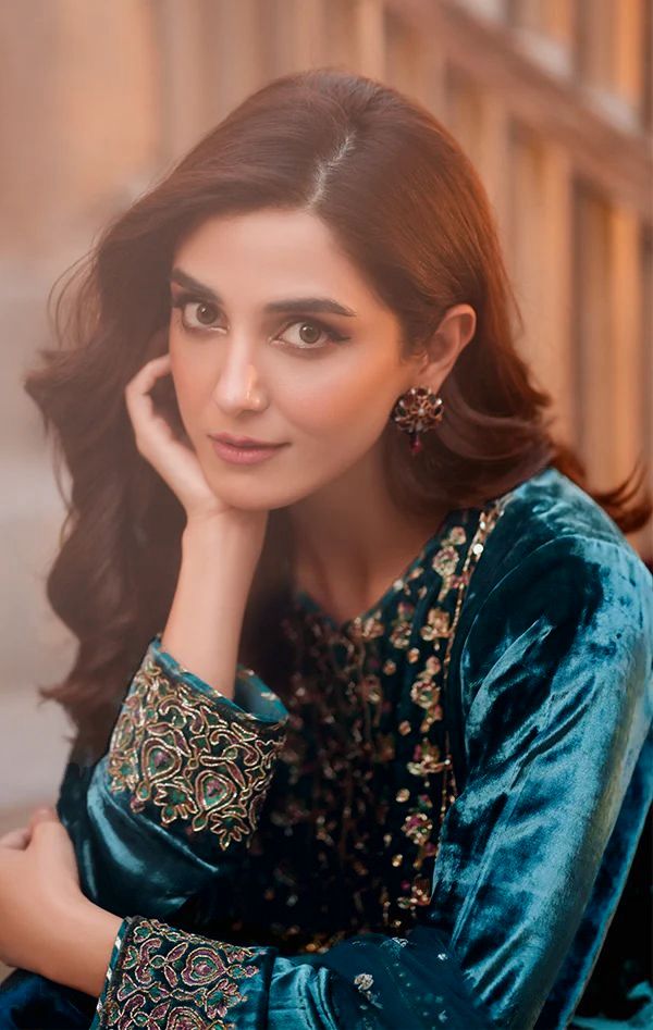 Woman posing elegantly in a Teal Blue Velvet Embroidered Kurti Plazzo Set.