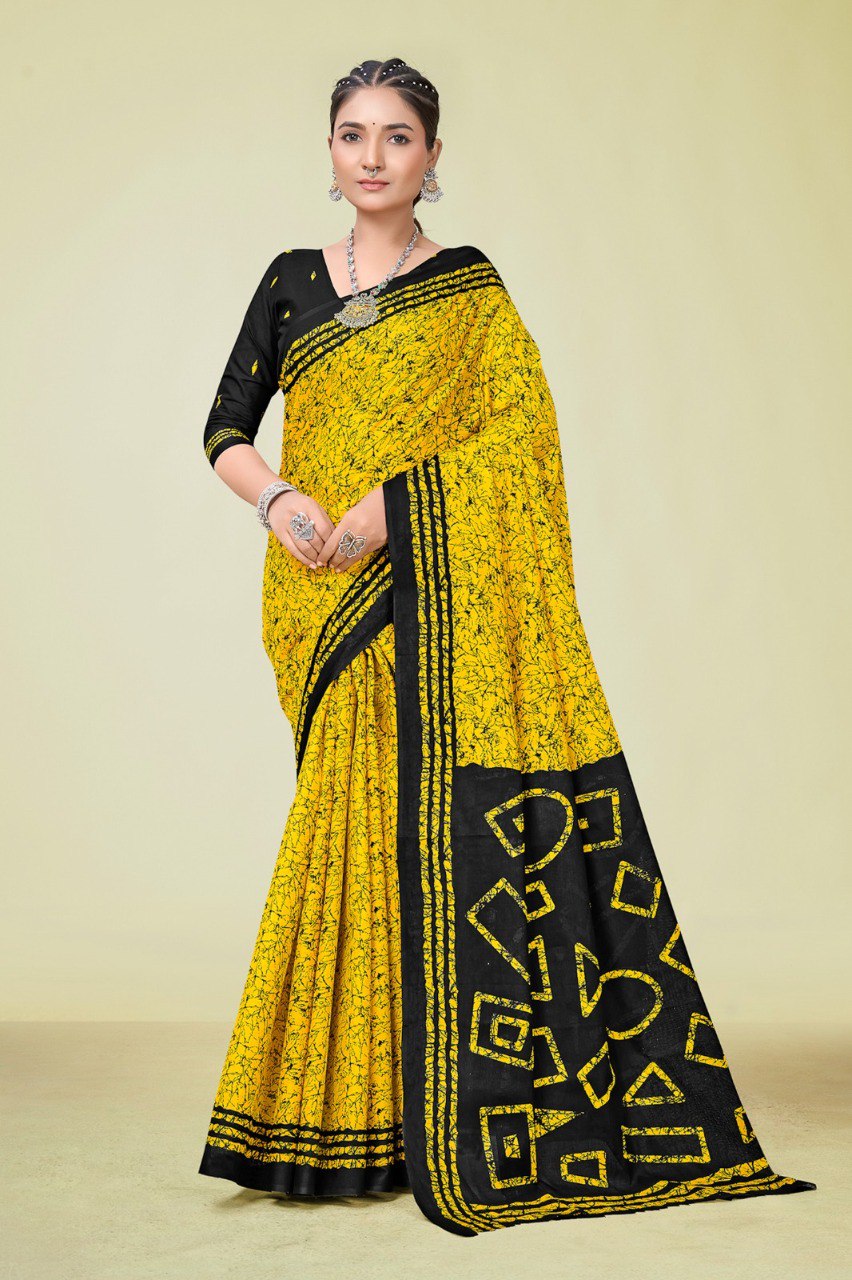 Model from front showcasing yellow Mal Mal cotton printed saree with black geometric patterns and black blouse