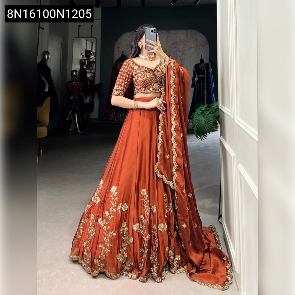 Full body shot of woman in rust Rangoli Silk Lehenga with intricate gold sequins and thread embroidery, front view