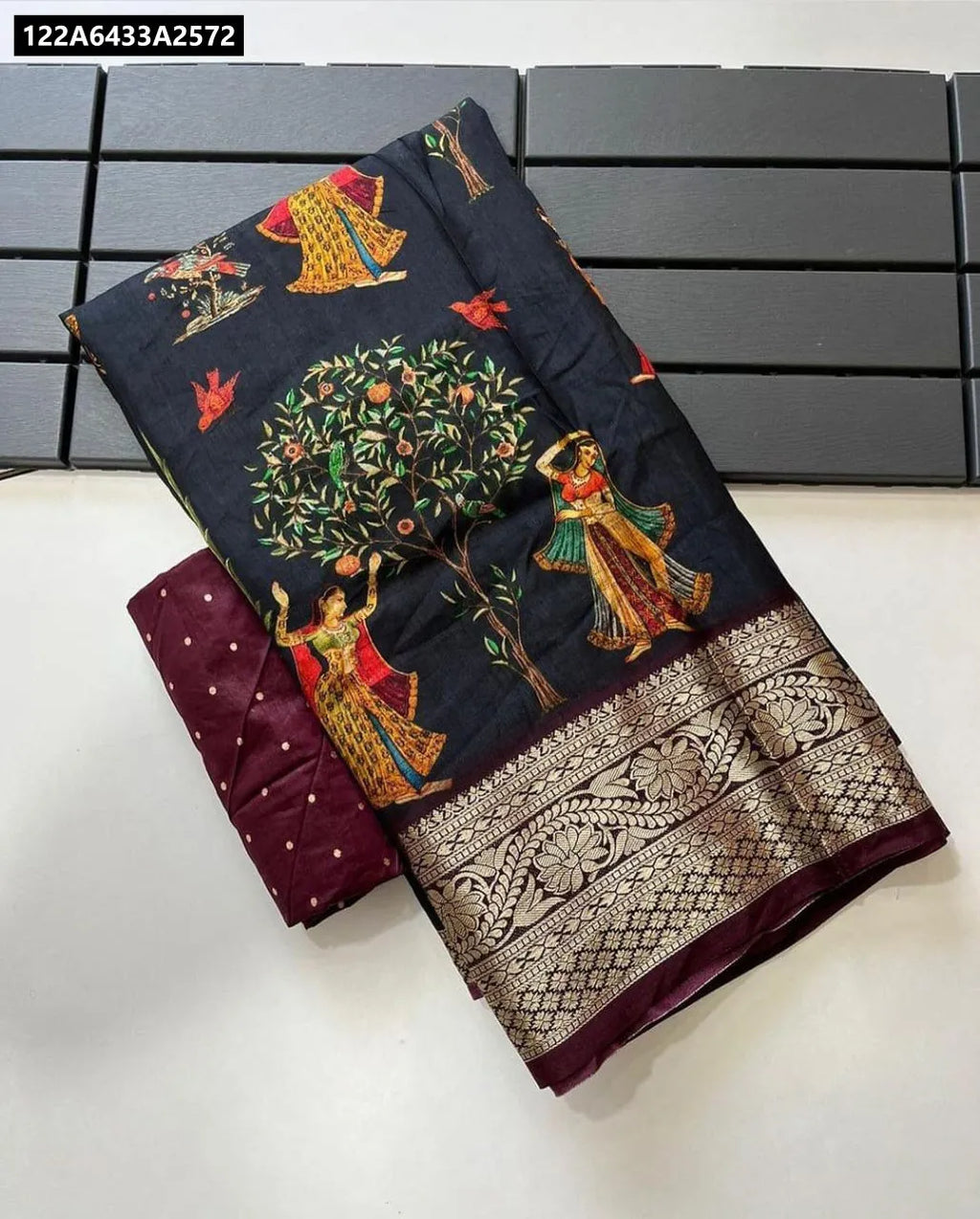 TRENDBUY Pichwai Kalamkari Dola Silk Saree with matching blouse piece, neatly folded on a dark grid background