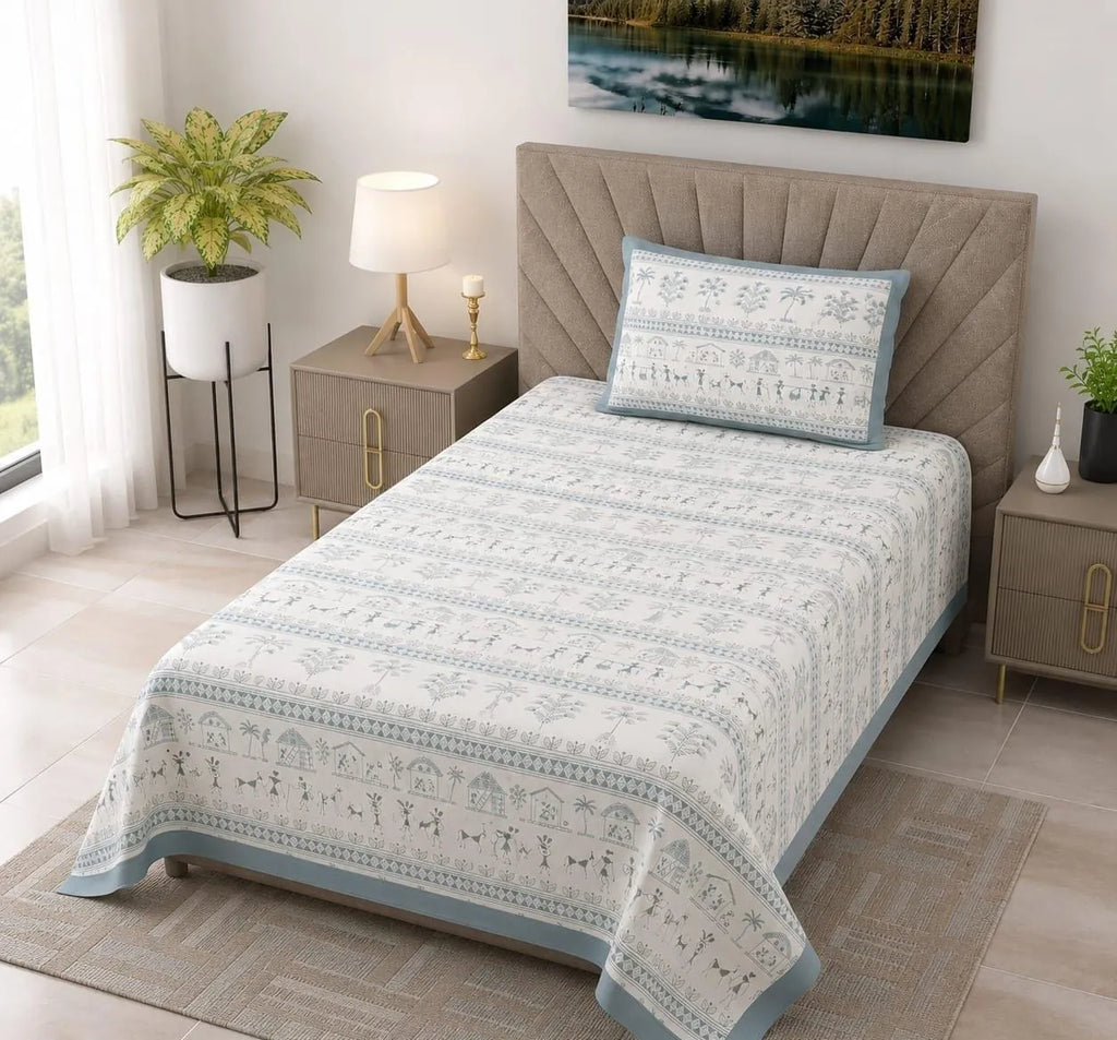 Single bed dressed in blue and white tribal folk print cotton bedsheet with matching pillow cover