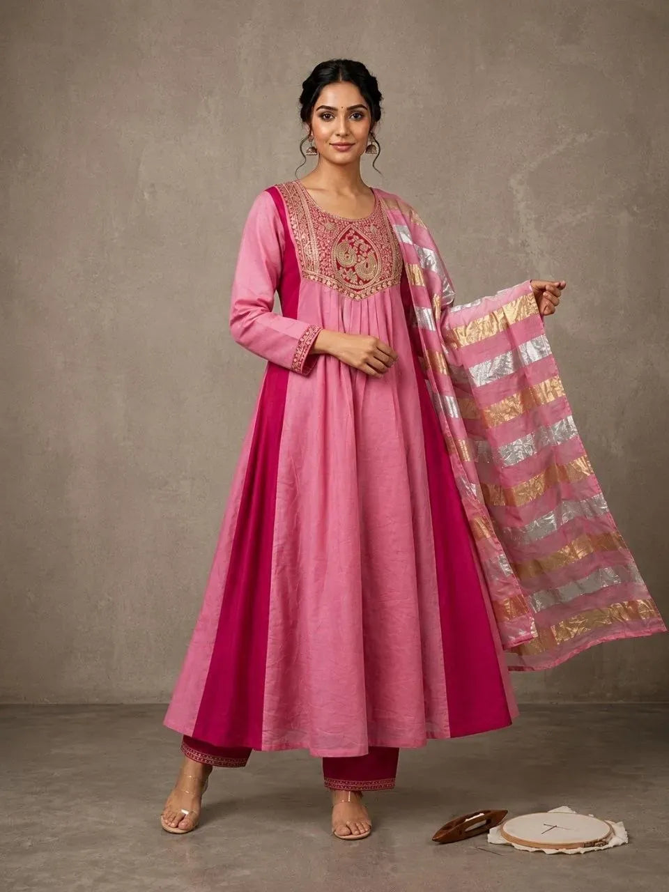 Full body shot of model wearing pink and magenta anarkali kurti set with striped dupatta
