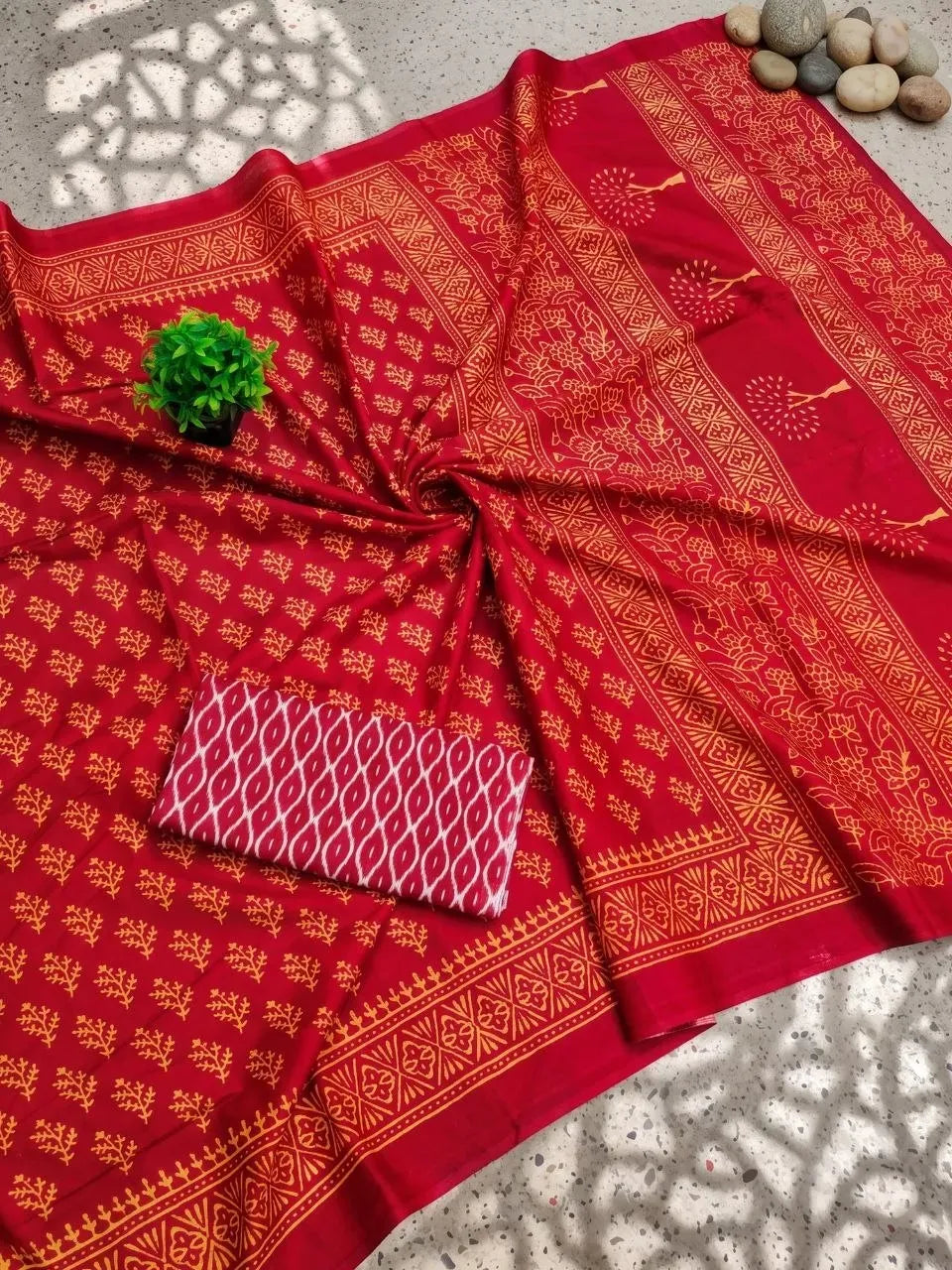 Red saree with gold floral Bagh print and folded blouse piece