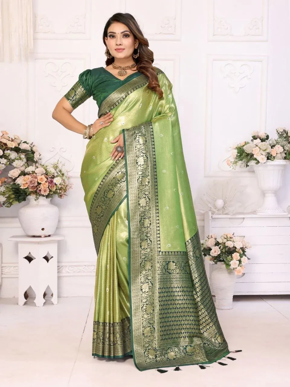 Model wearing light green banarasi tissue silk saree with dark green border