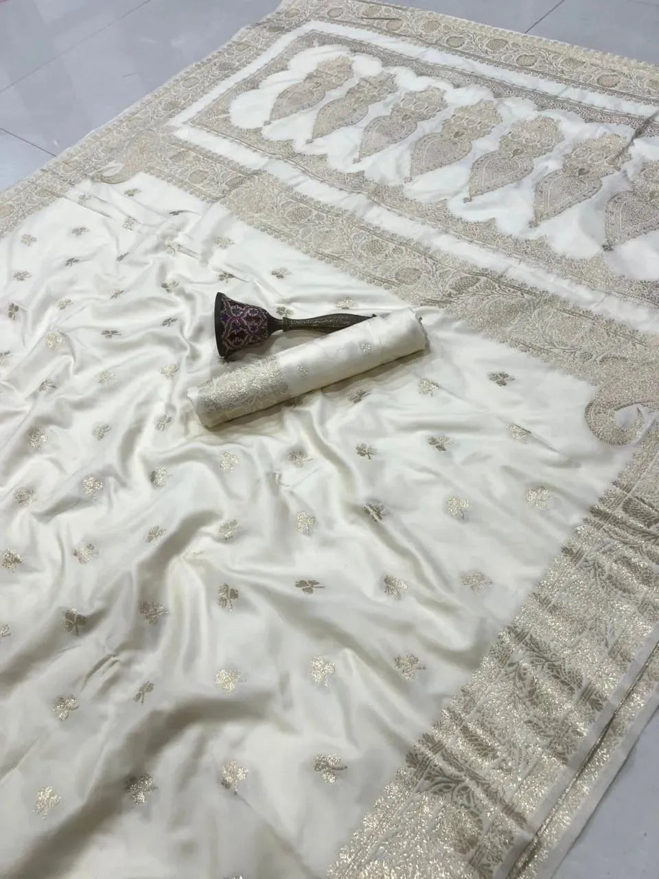 White pure banarasi silk saree with gold zari weave and matching blouse piece
