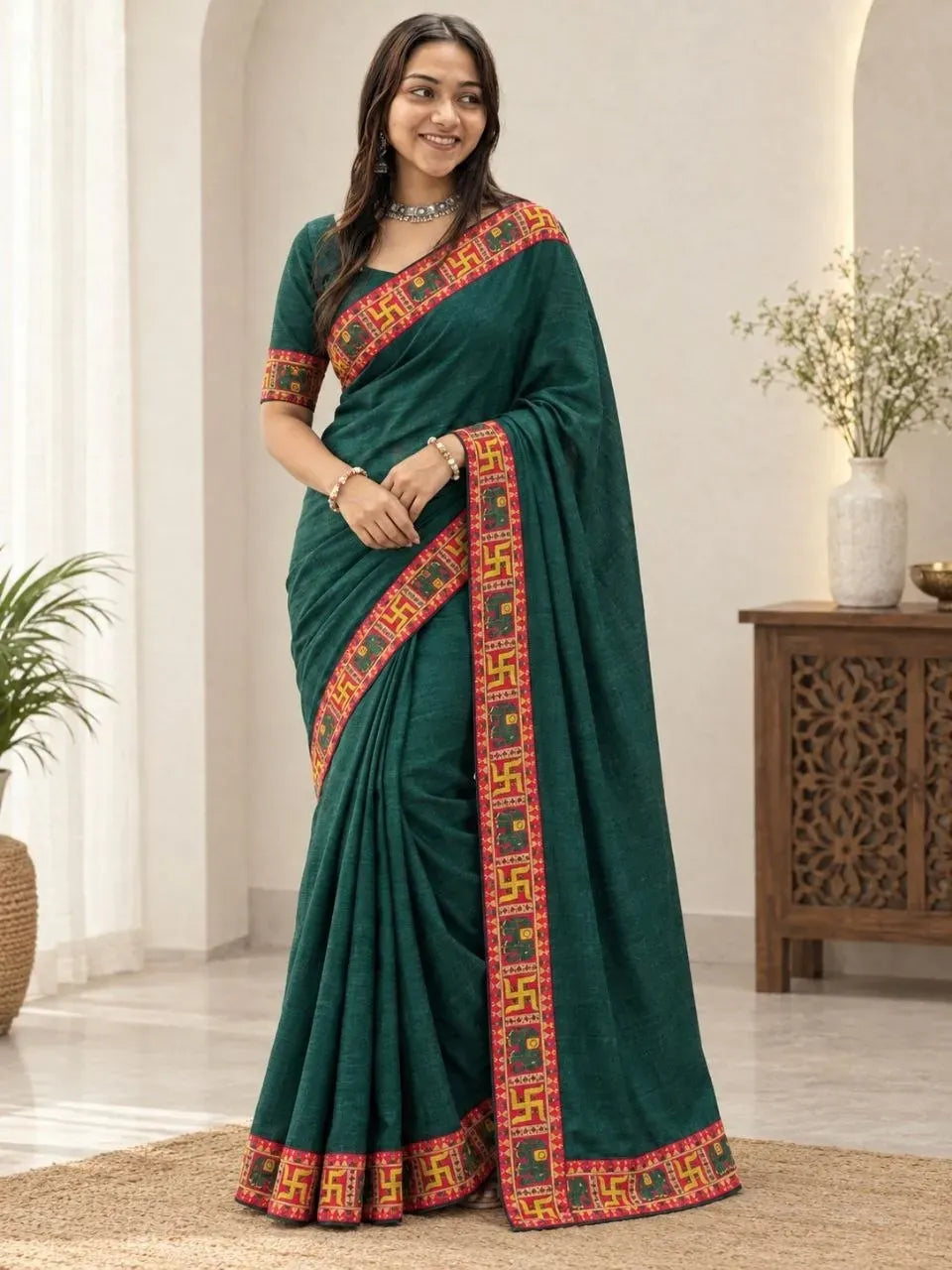Front facing full body view of model in bottle green festive saree