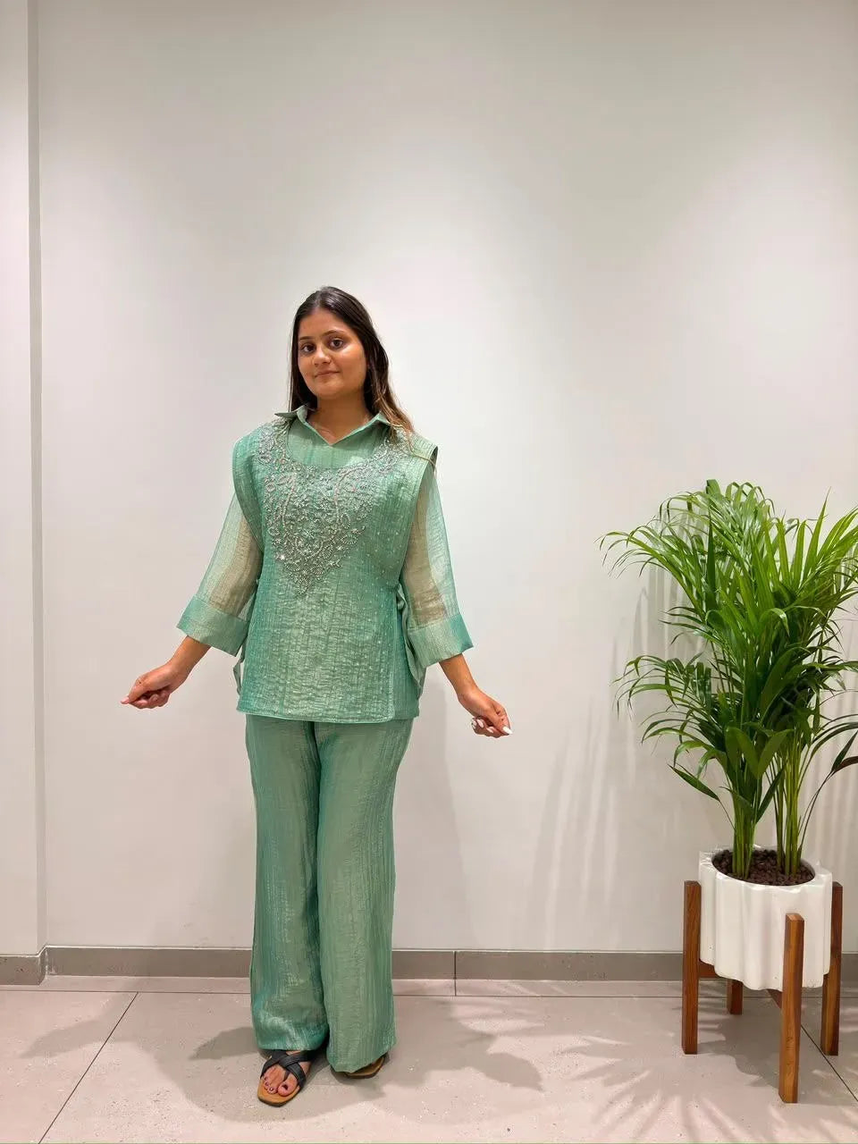 Front facing view of model posing in mint green chanderi cotton kurti set