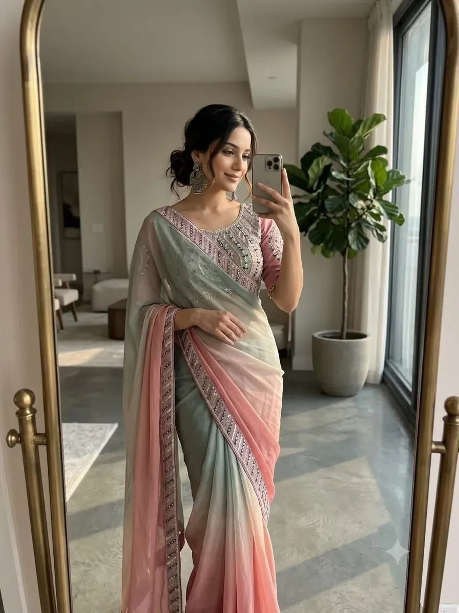 Model in mirror selfie wearing soft chiffon ombre saree with heavy border