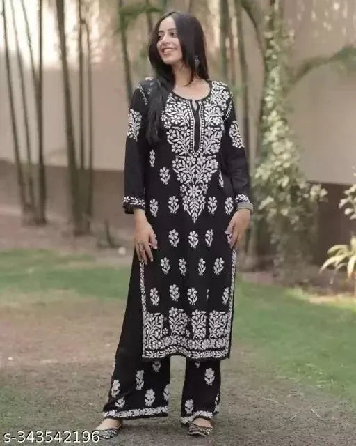 Model wearing black chikankari kurti with palazzo and white embroidery