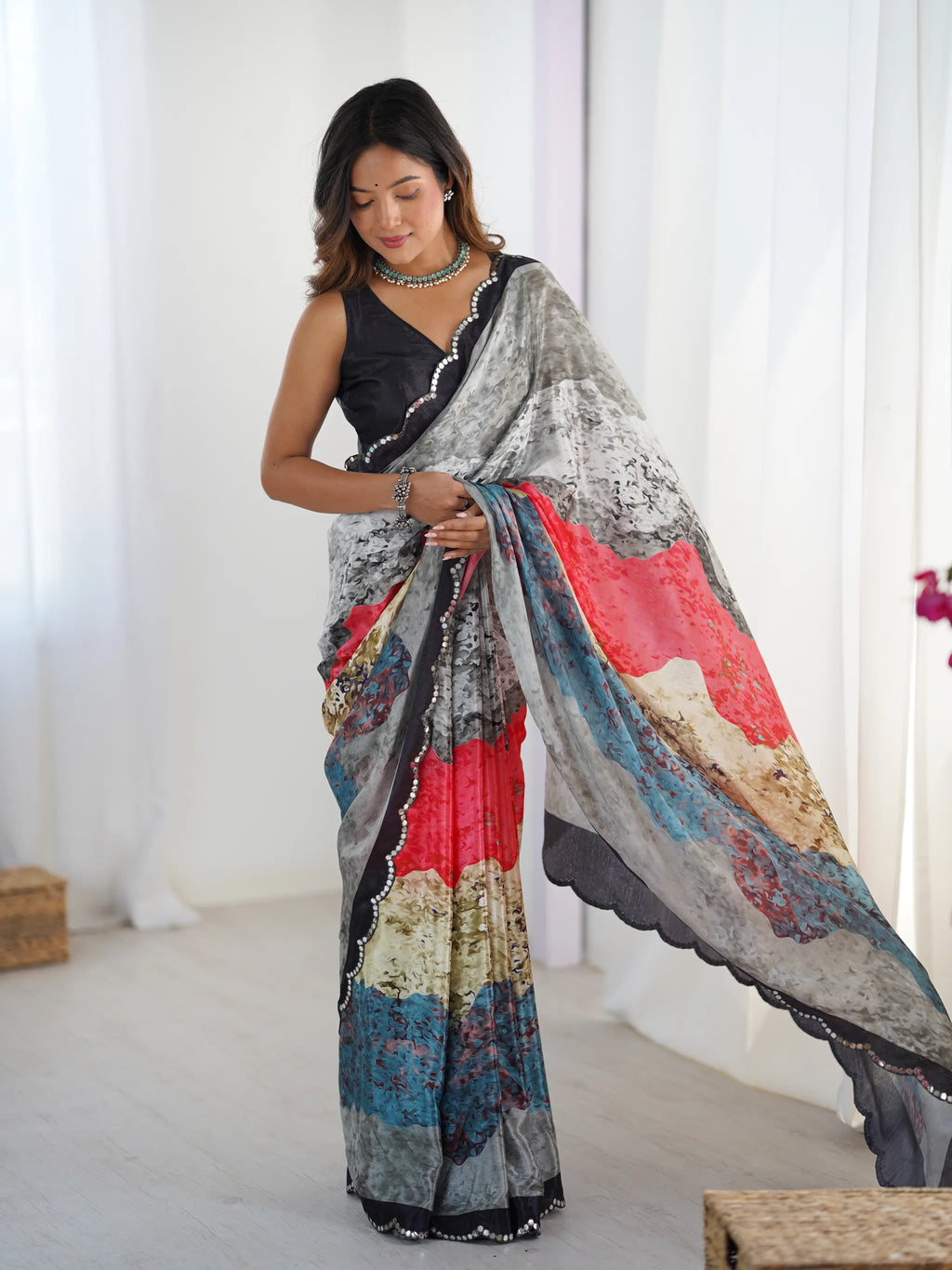 Full view of model posing in printed chinnon saree with mirror lace border