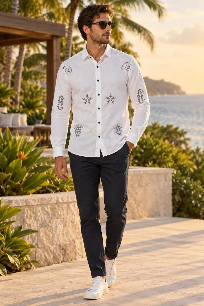 Full body front view of model wearing white embroidered cotton shirt with dark trousers