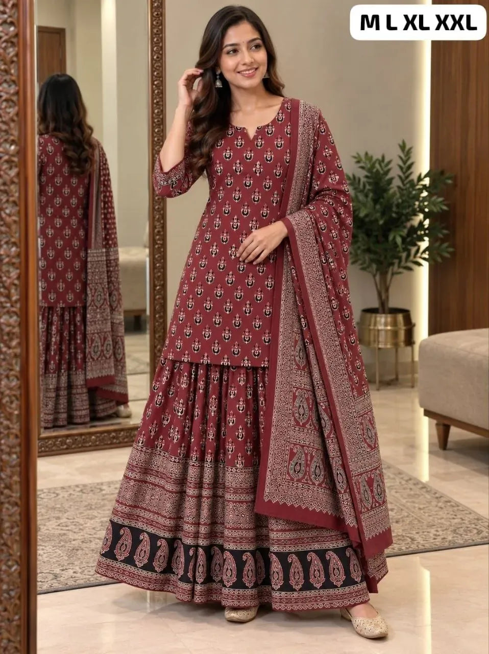 Model wearing maroon printed gopi dress set with kurti, skirt, and dupatta