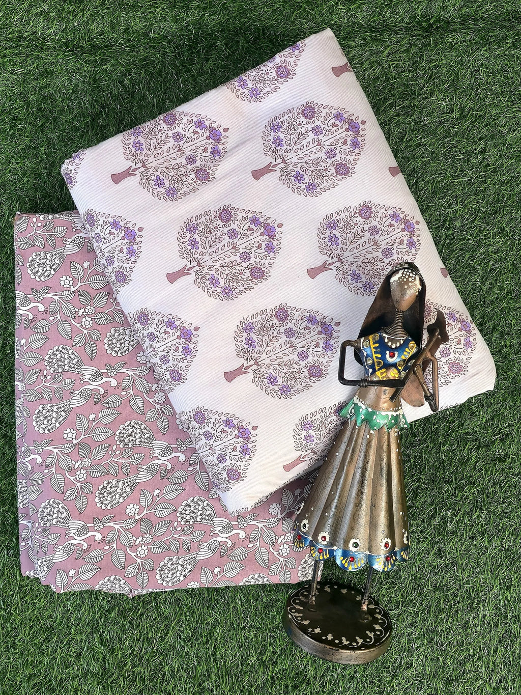 Purple tree print pure cotton single dohar folded on grass with decorative figurine