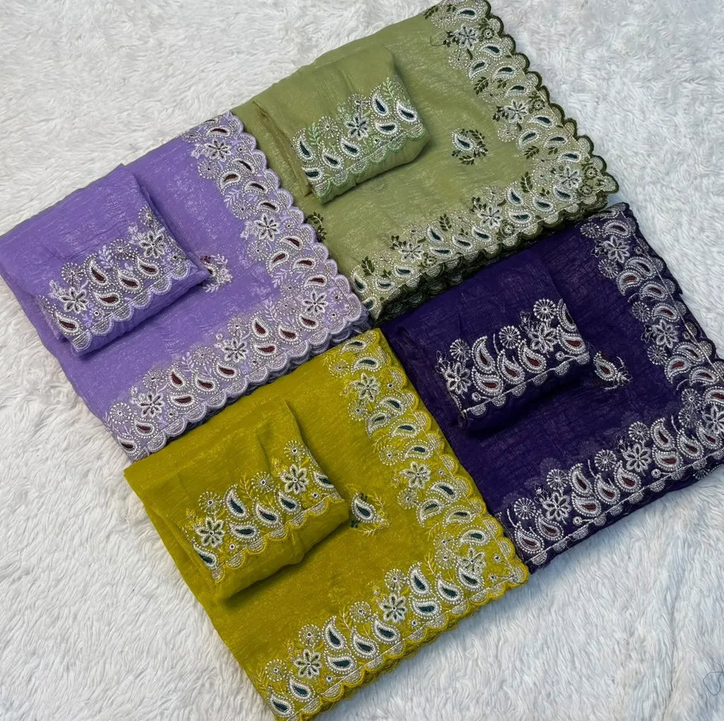 Folded crunchy silk sarees in various colors on white fur background
