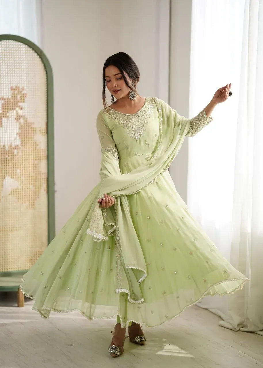 Model wearing light green embroidered Anarkali suit in studio lighting