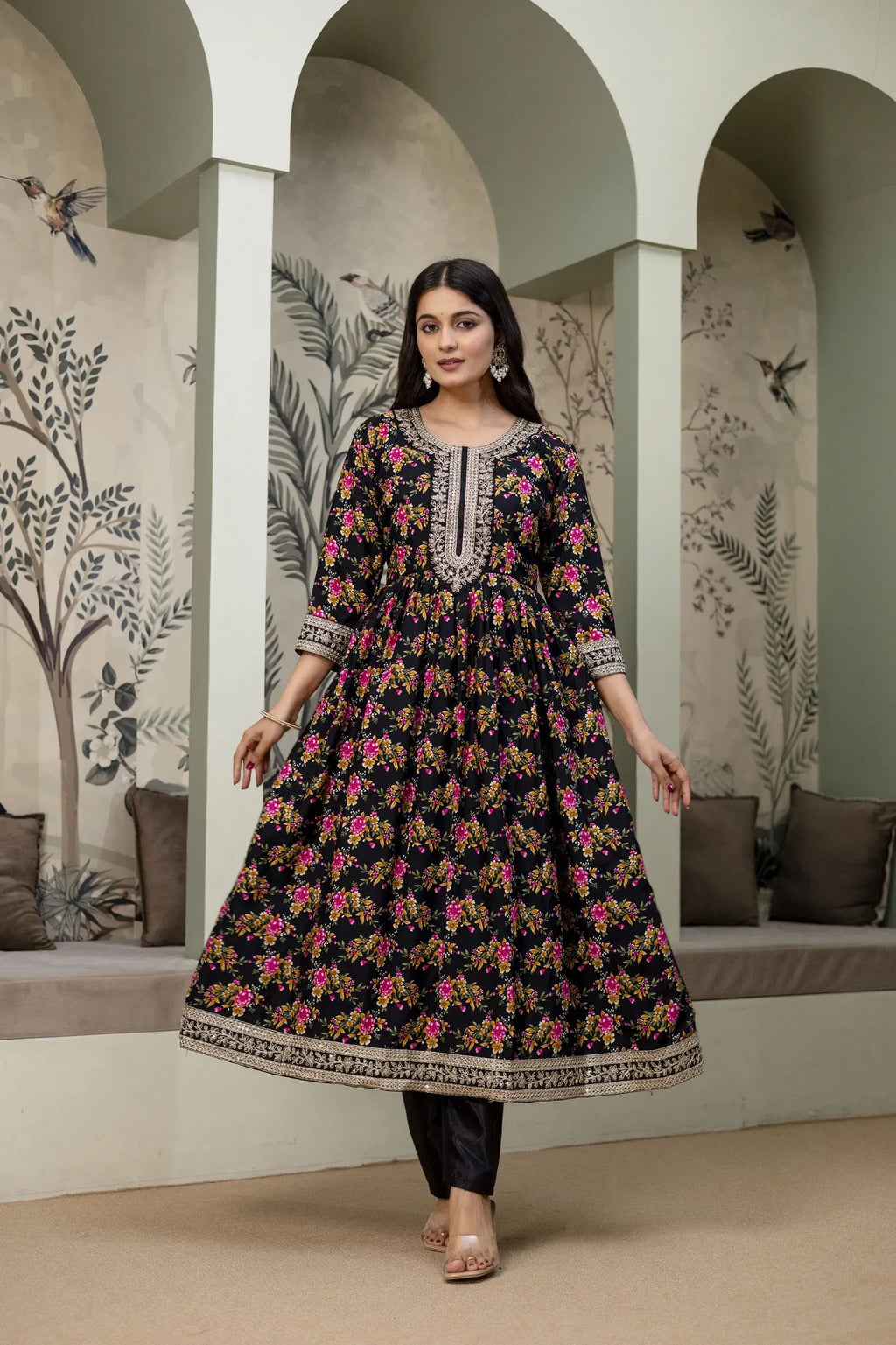 Full length view of woman posing in black floral ethnic gown set