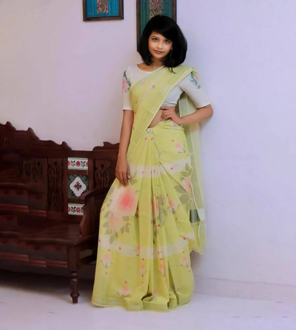 Model wearing pastel yellow digital print linen saree with silver jari patta