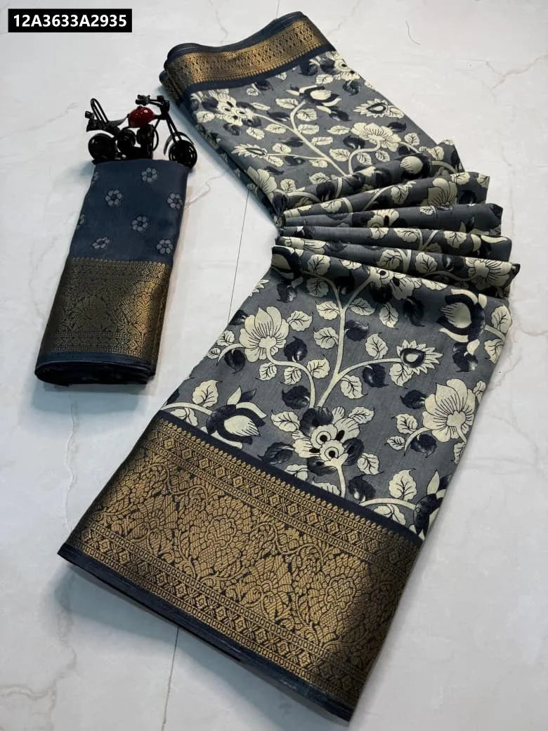TRENDBUY Premium Dola Silk Saree in Charcoal Grey with intricate cream and black floral print and rich golden jari border, laid out on a white marble surface with a matching blouse piece.