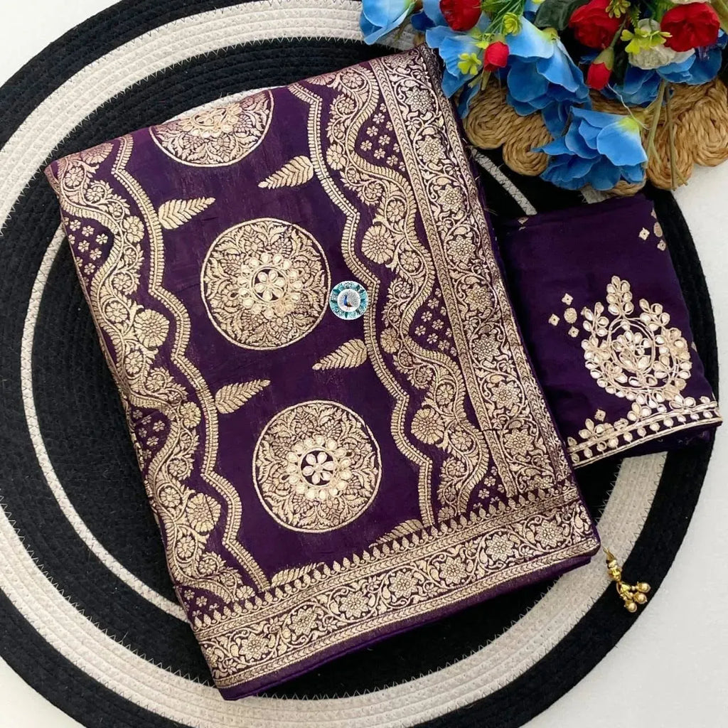 Folded purple dola viscose saree with intricate gold embroidered pallu