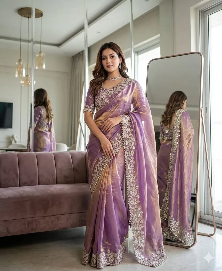 Model posing in elegant lavender satin saree with heavy embroidery