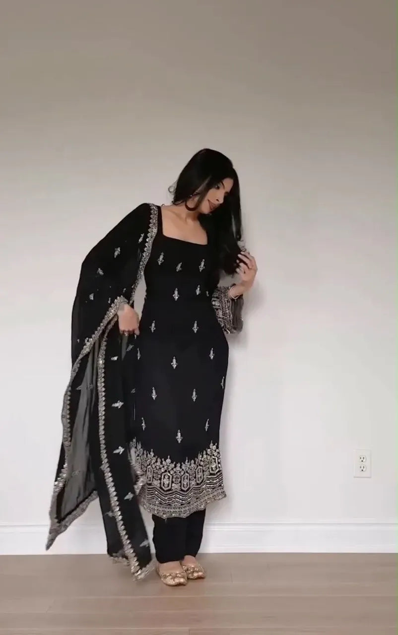 Full body view of woman wearing black embroidered georgette kurti set