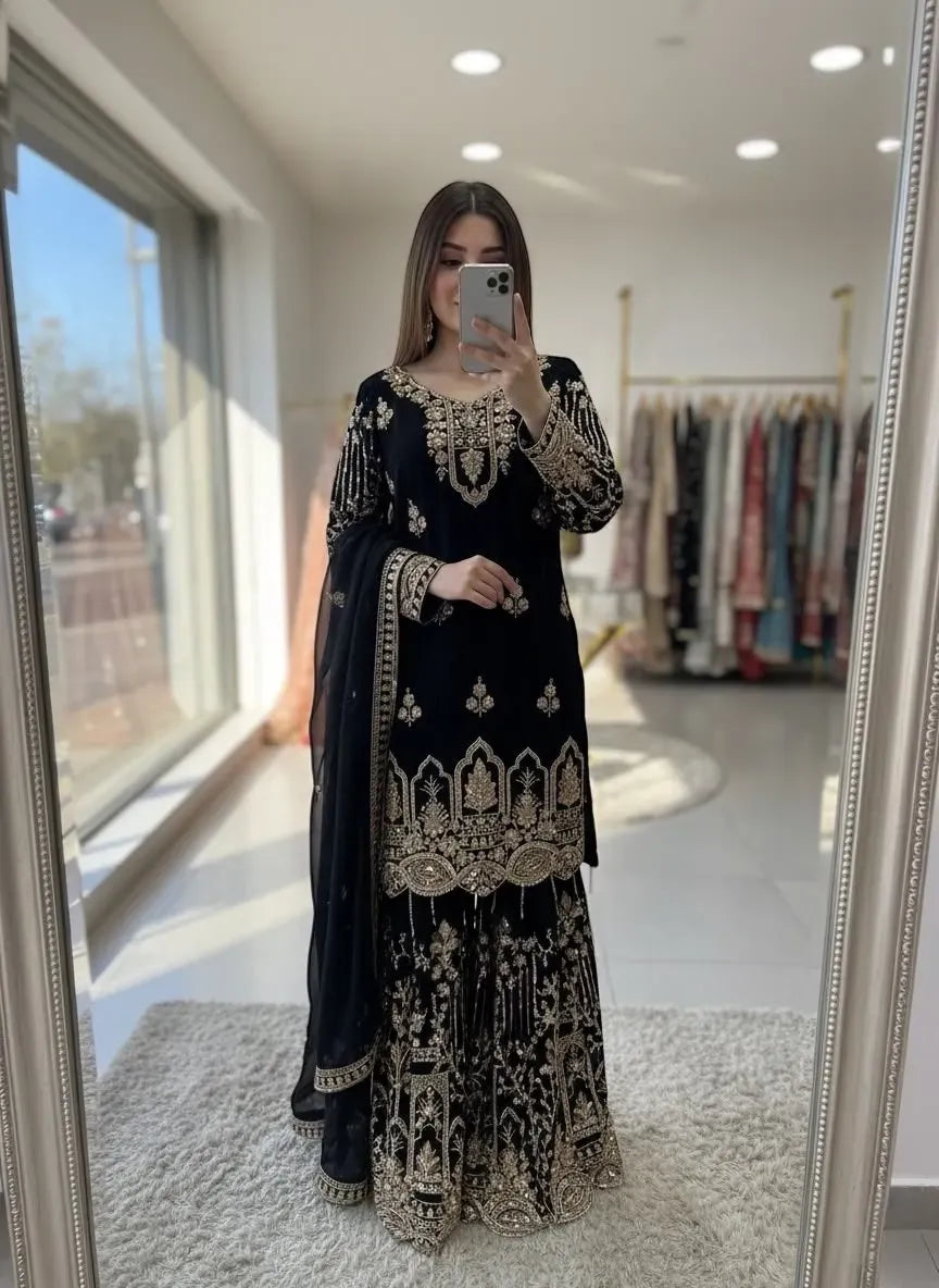 Model wearing black fox georgette sharara set with heavy embroidery