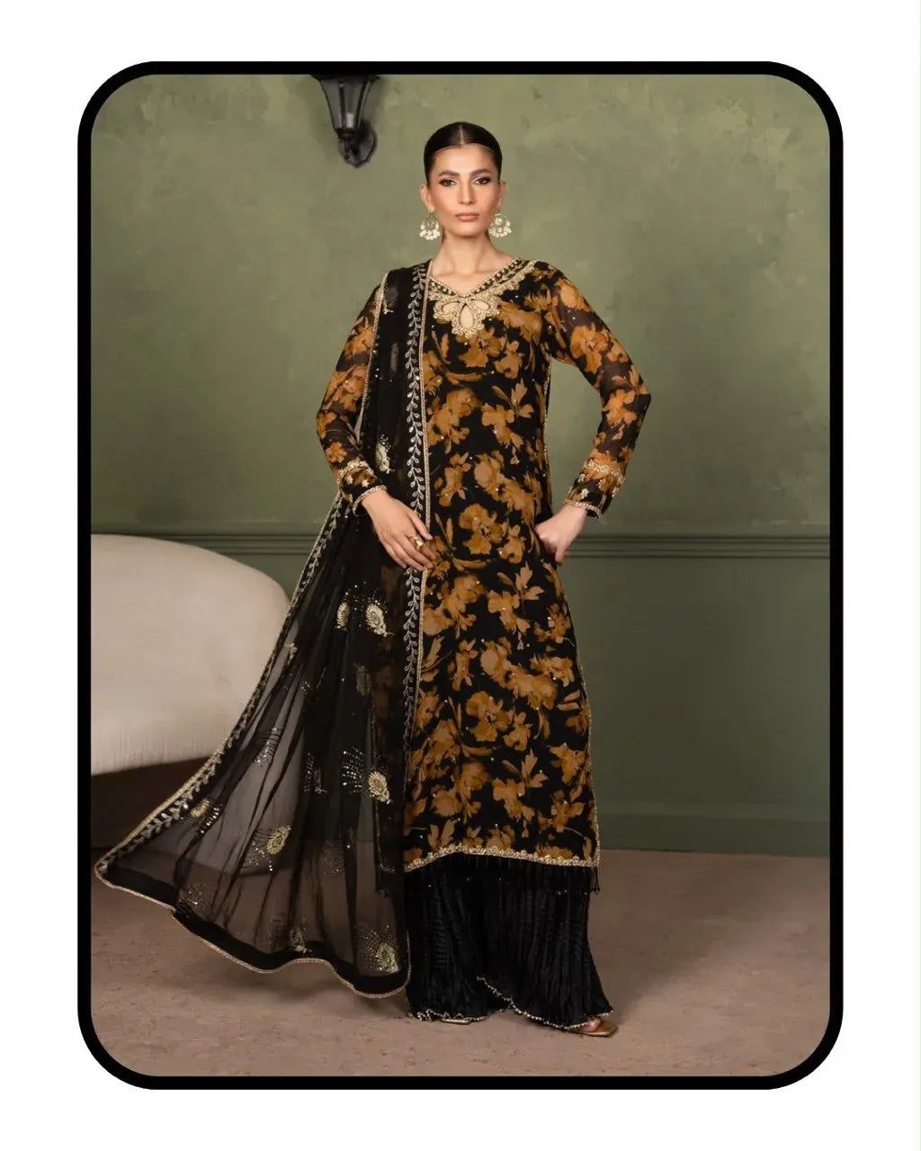 Model wearing premium black georgette palazzo suit with heavy gold embroidery on the neckline and dupatta