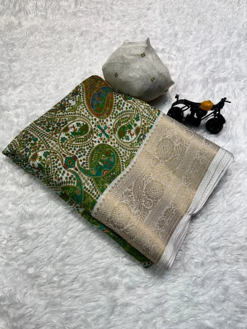 Neatly folded georgette saree with intricate ajrakh pattern and gold border