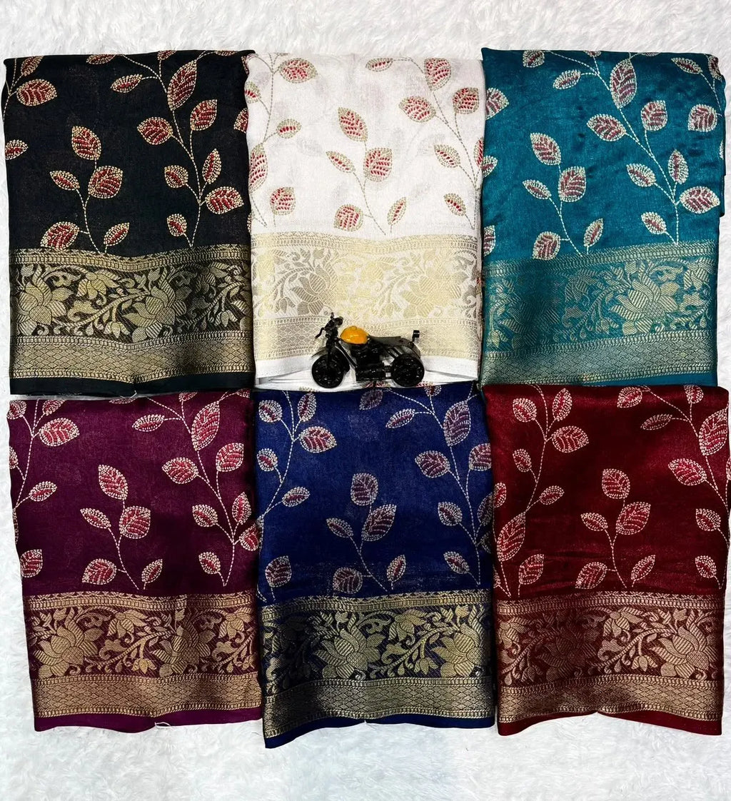Multiple colored georgette sarees folded together showing various shades