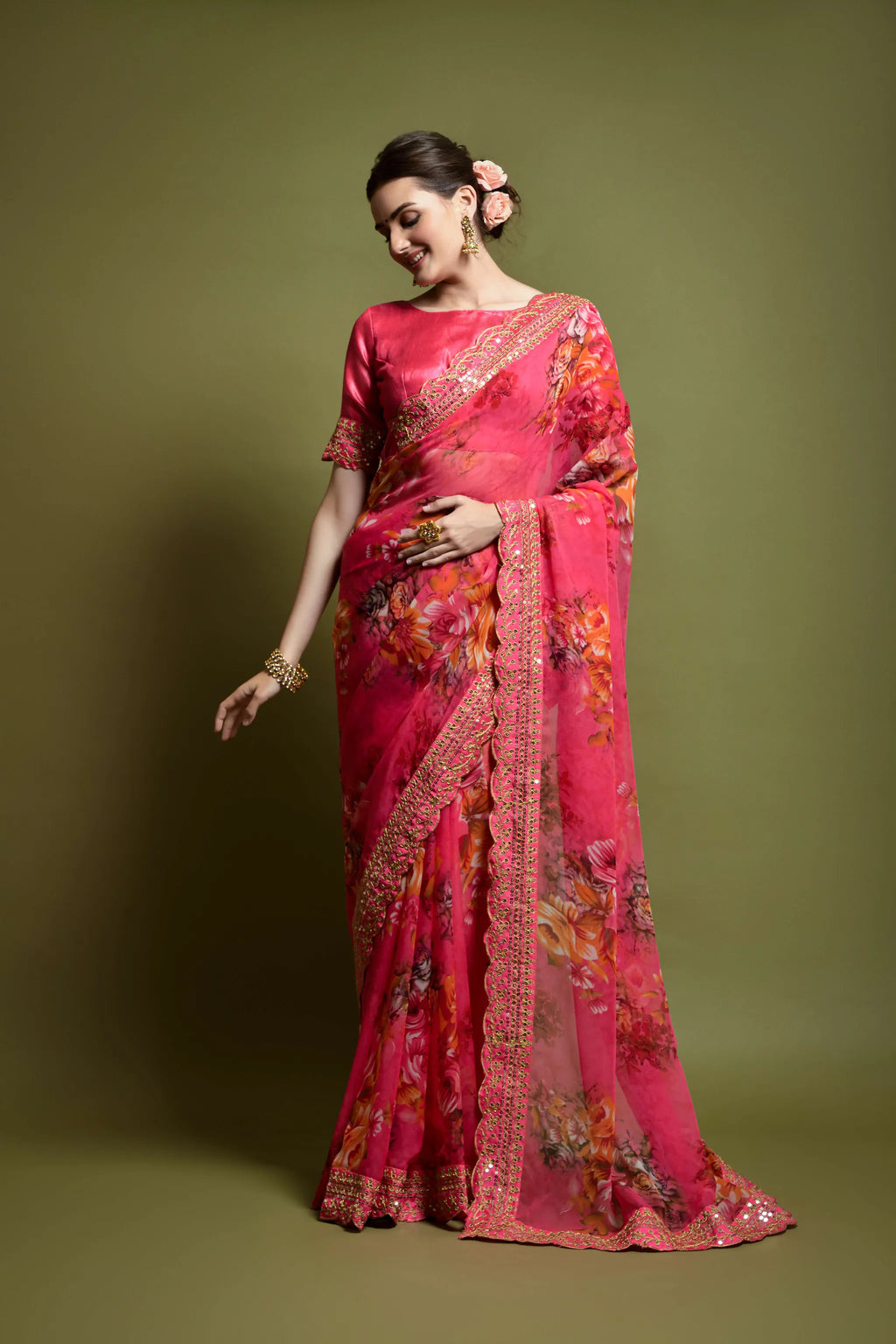 Model posing gracefully in pink floral print georgette saree