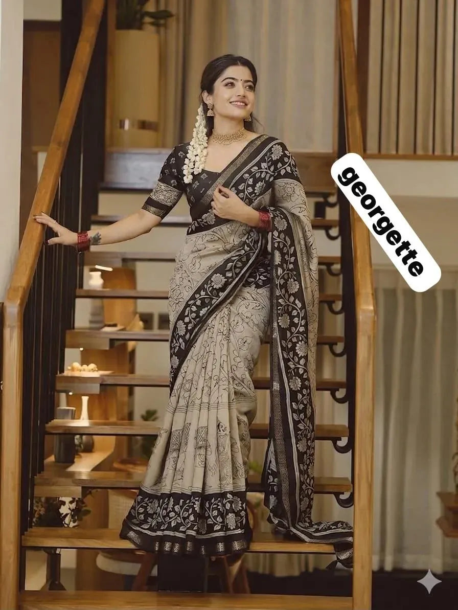 Model standing on stairs posing gracefully in beige and black georgette saree
