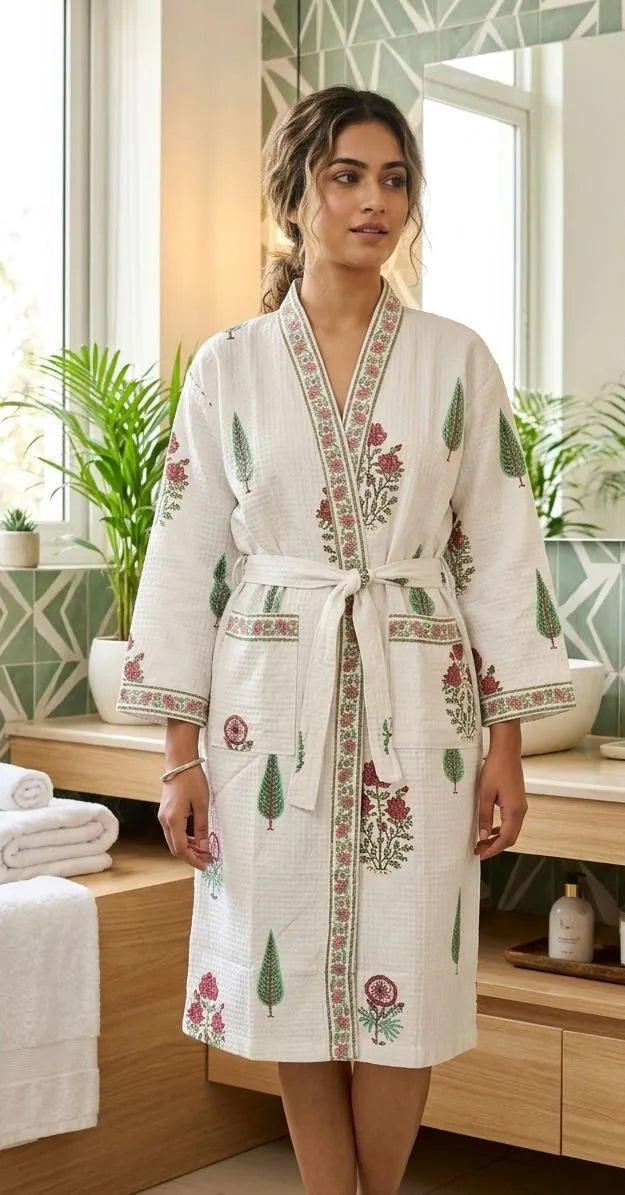 Woman wearing white waffle bathrobe with green and pink handblock floral print