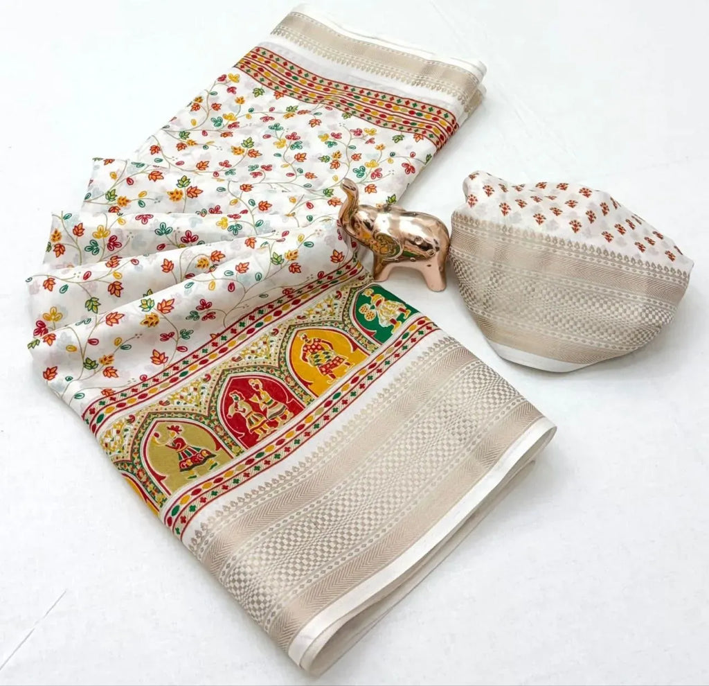 Folded white handloom saree with multicolor floral pattern and gold elephant showpiece