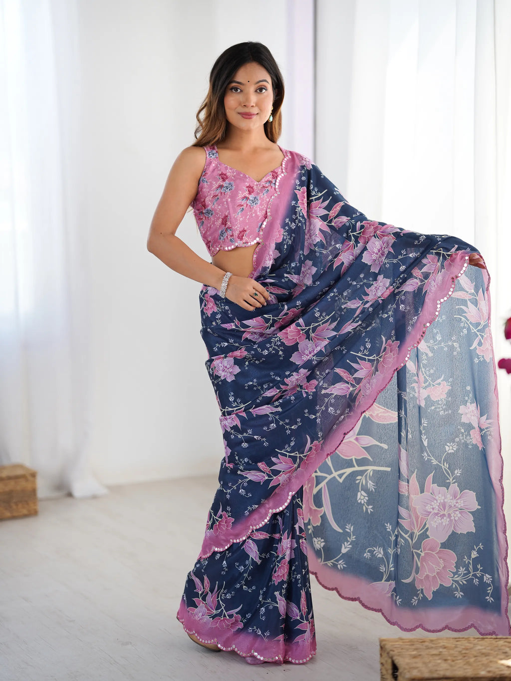 Full length front pose of model in navy blue and pink chinnon party wear saree