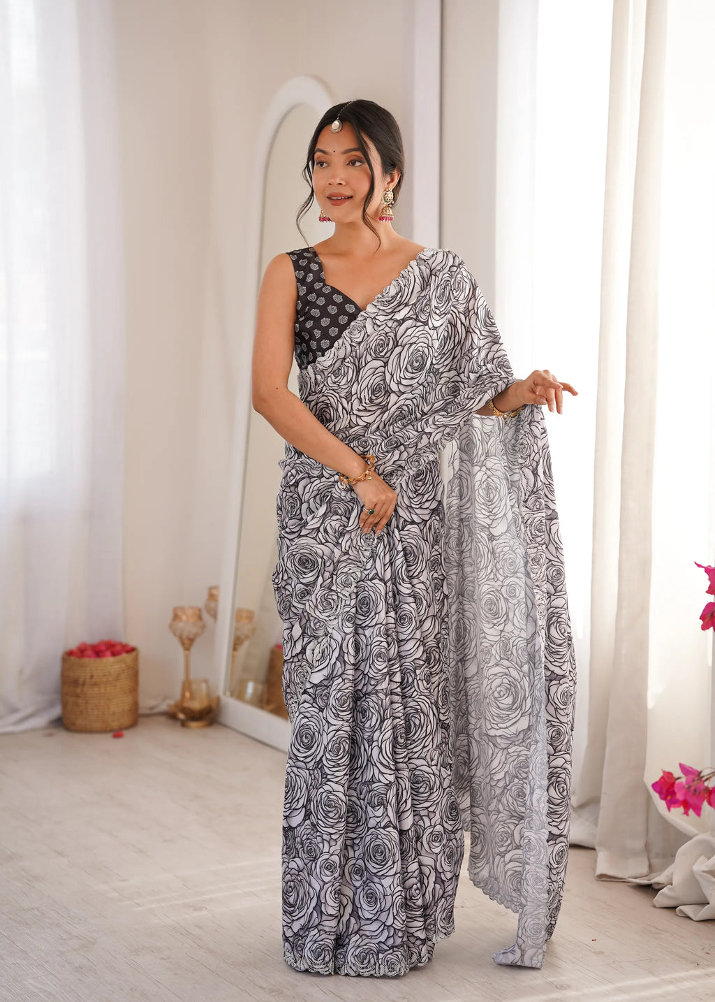 Model wearing black and white floral print chinnon saree with sworski work