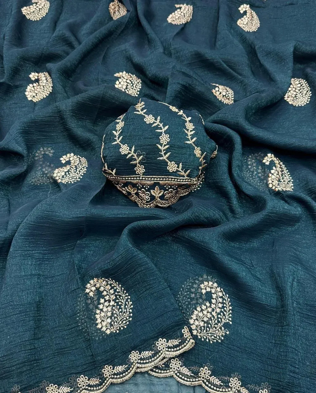 Dark teal green georgette saree with gold paisley motifs and matching blouse piece
