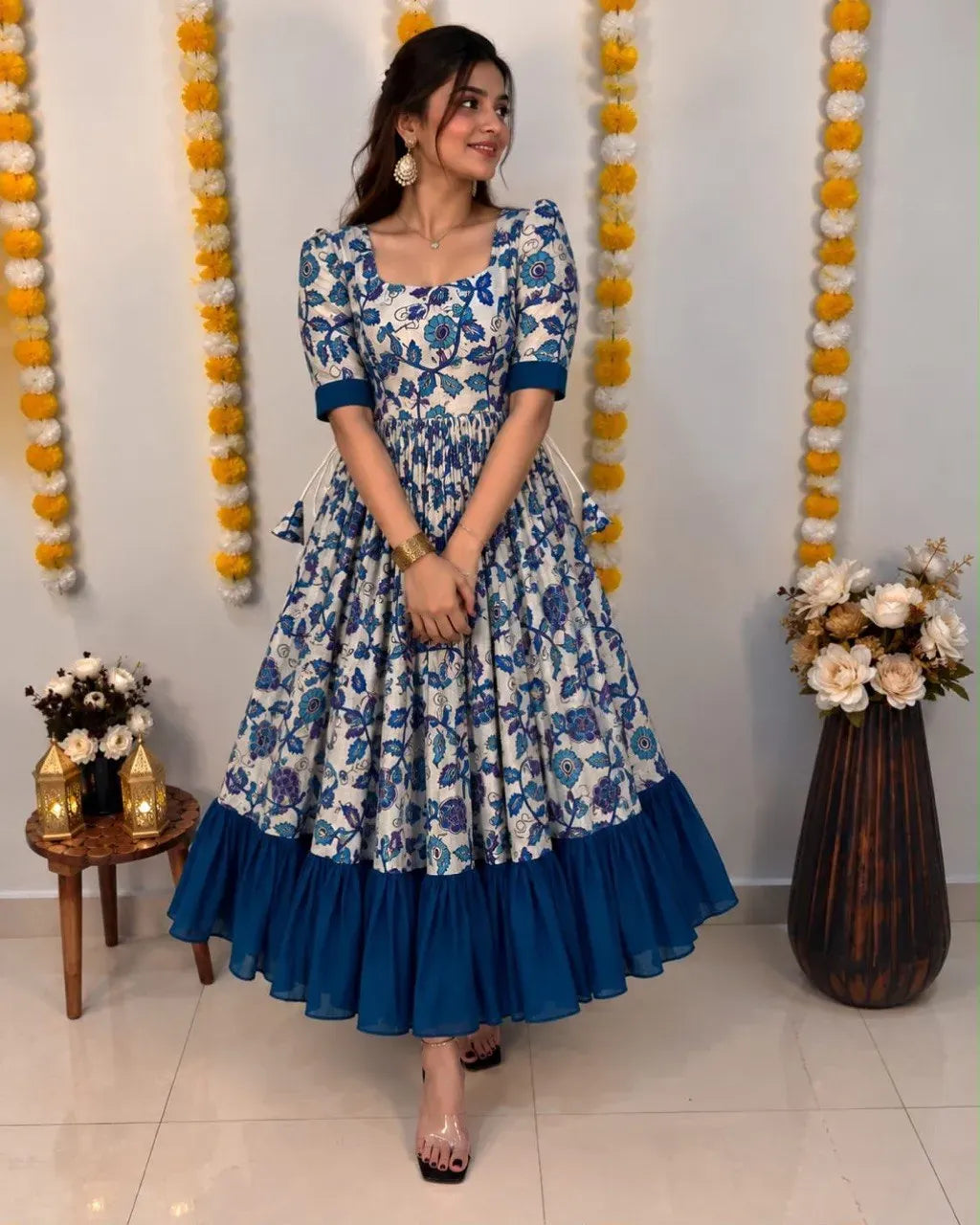 Model wearing white and blue Kalamkari silk dress with contrast ruffles