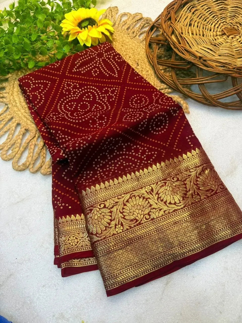 Folded maroon Kanjivaram Bandhani saree with gold zari border