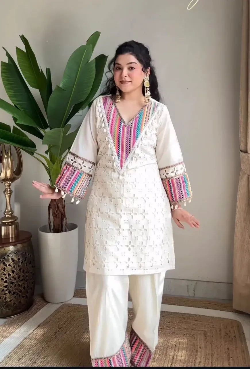Front view of model showcasing the straight fit off-white khadi cotton top and matching farsi pants with vibrant borders