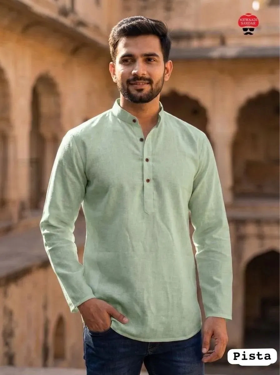 Man wearing a pista green khadi linen short kurta with wooden buttons, standing outdoors