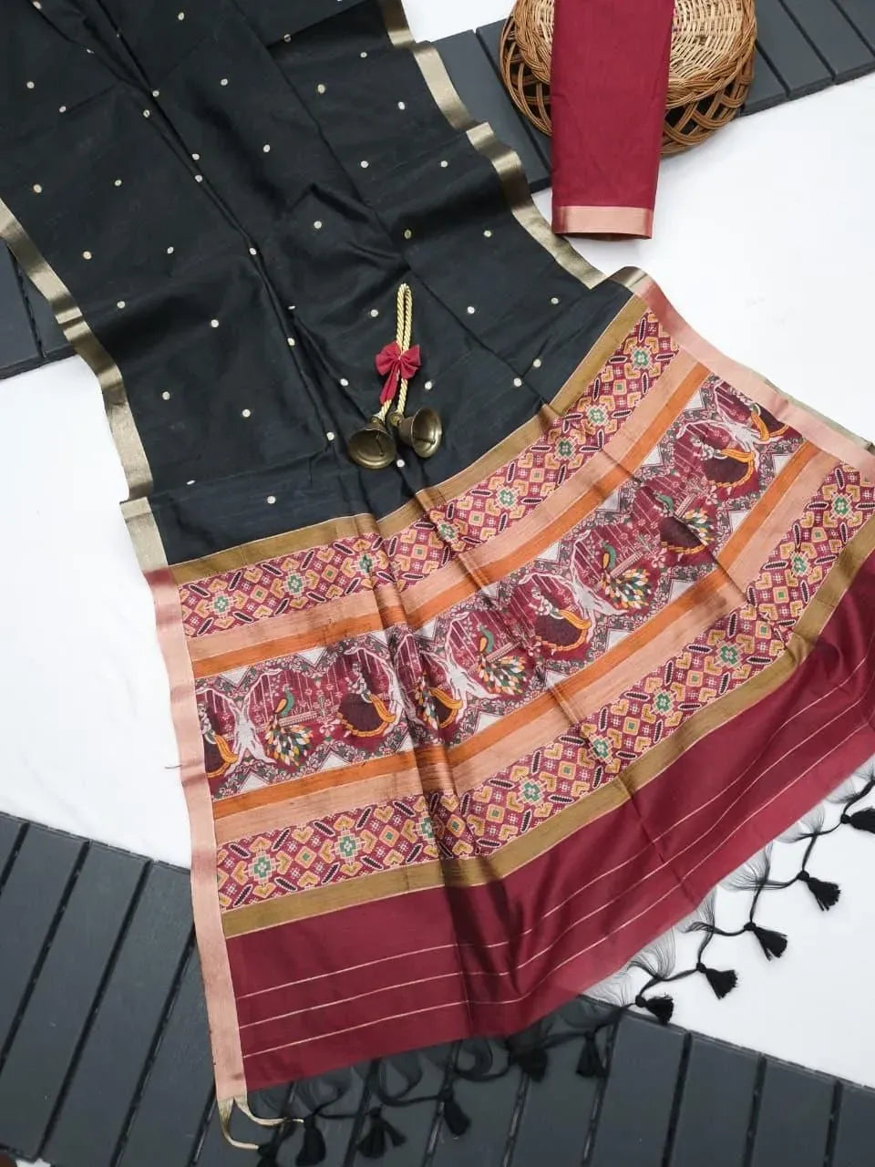 Black khadi raw silk saree with gold dots and maroon patola pallu