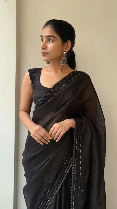 Model wearing black Kota Doriya saree with traditional silver earrings