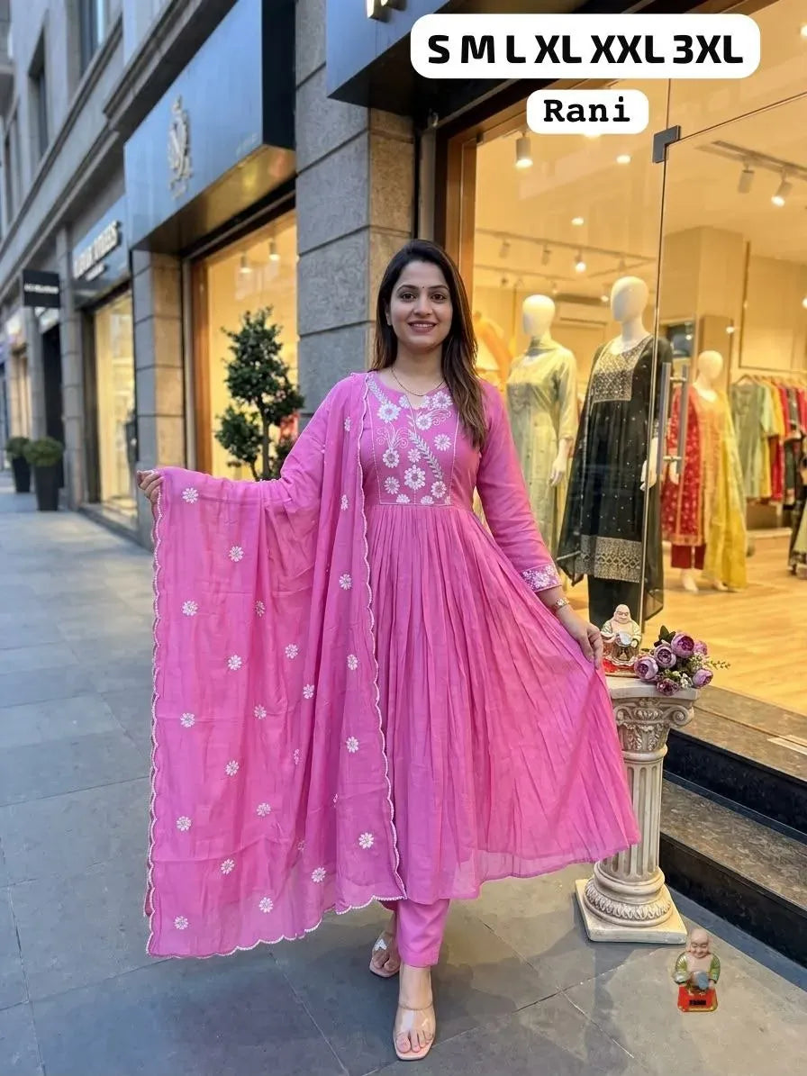 Model wearing pink traditional Anarkali suit set outside boutique